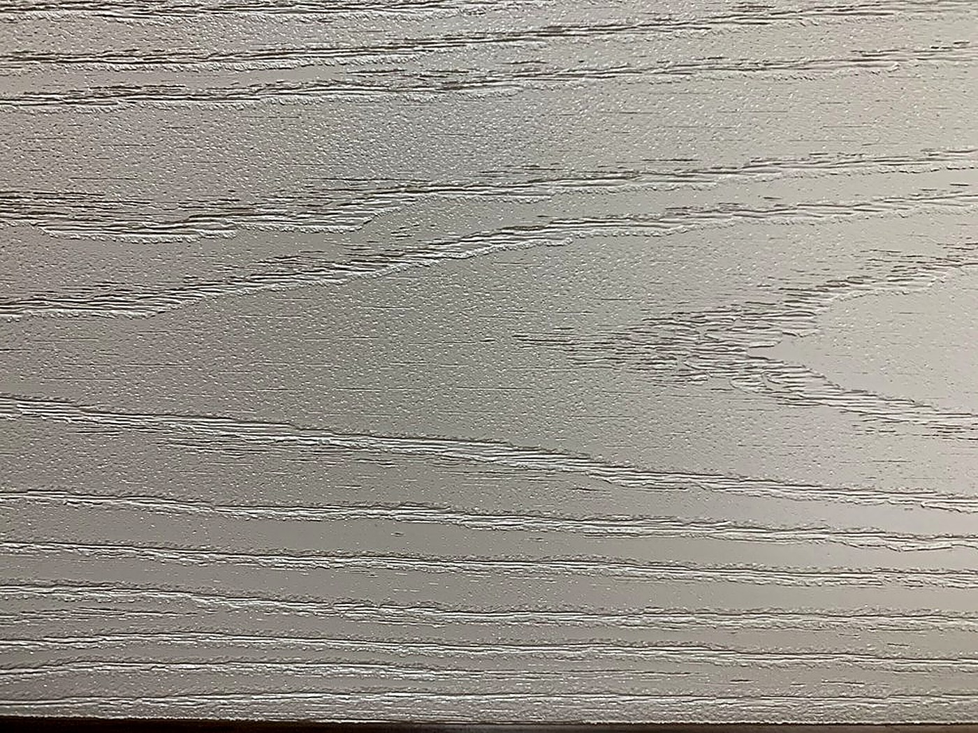 Close-up of an embossed woodgrain finish on a Patwin cellular PVC deck board.